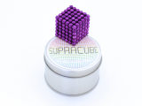 Cube violet posé sur sa boite